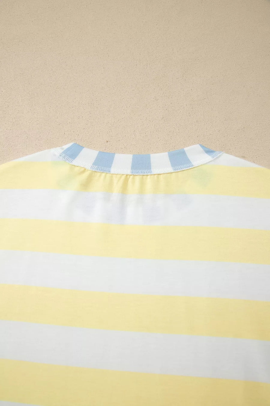 T-shirt with yellow and white horizontal stripes and a blue striped collar.