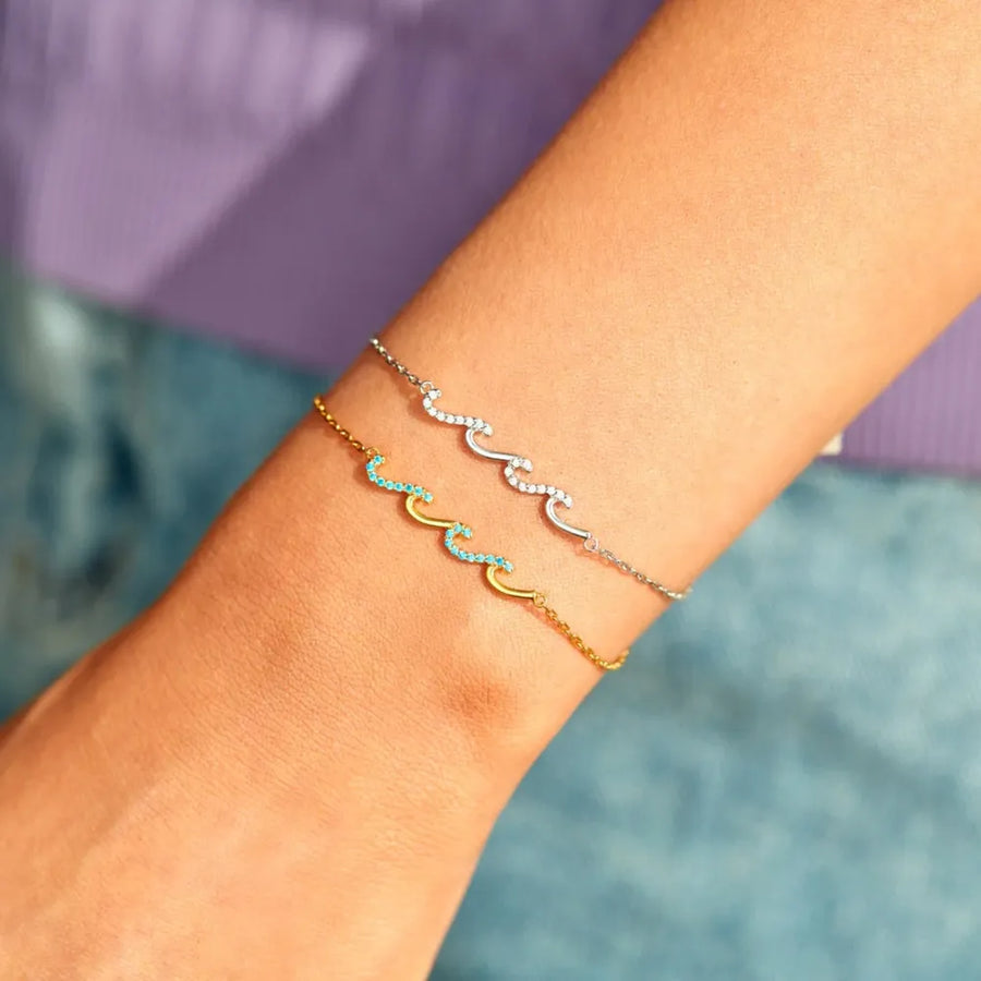 Ocean Wave Zirconia Bracelet in gold with turquoise stones and silver with white stones.
