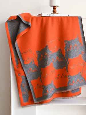 Reversible orange and gray scarf with a repeating cat pattern.