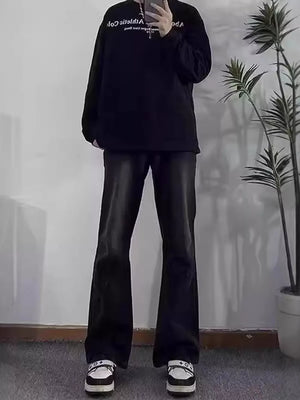 Men's black cotton flare jeans with pockets, styled with a black sweatshirt and sneakers.