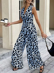 Sleeveless leopard print wide leg jumpsuit with V-neck and belted waist in blue and black animal print.