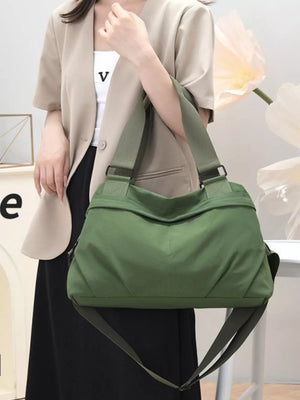 Green nylon tote bag with adjustable straps and front pocket detail
