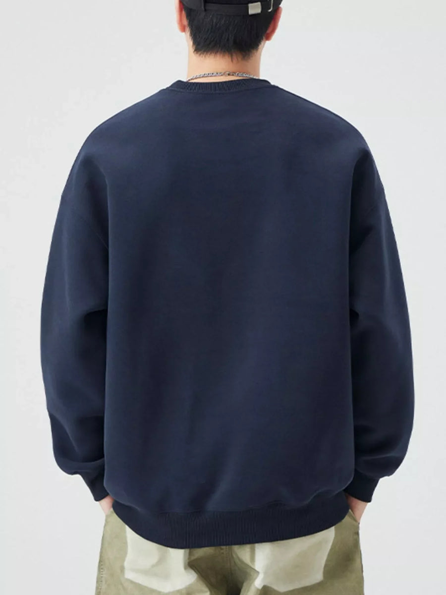 Navy blue oversized crew-neck sweatshirt with ribbed cuffs and hem.