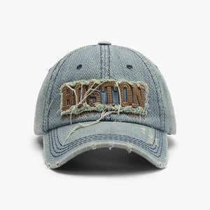 Distressed denim baseball cap with embroidered Boston text and frayed details.