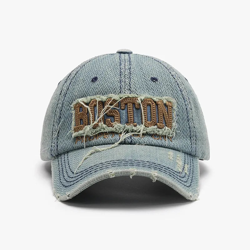 Distressed denim baseball cap with embroidered Boston text and frayed details.