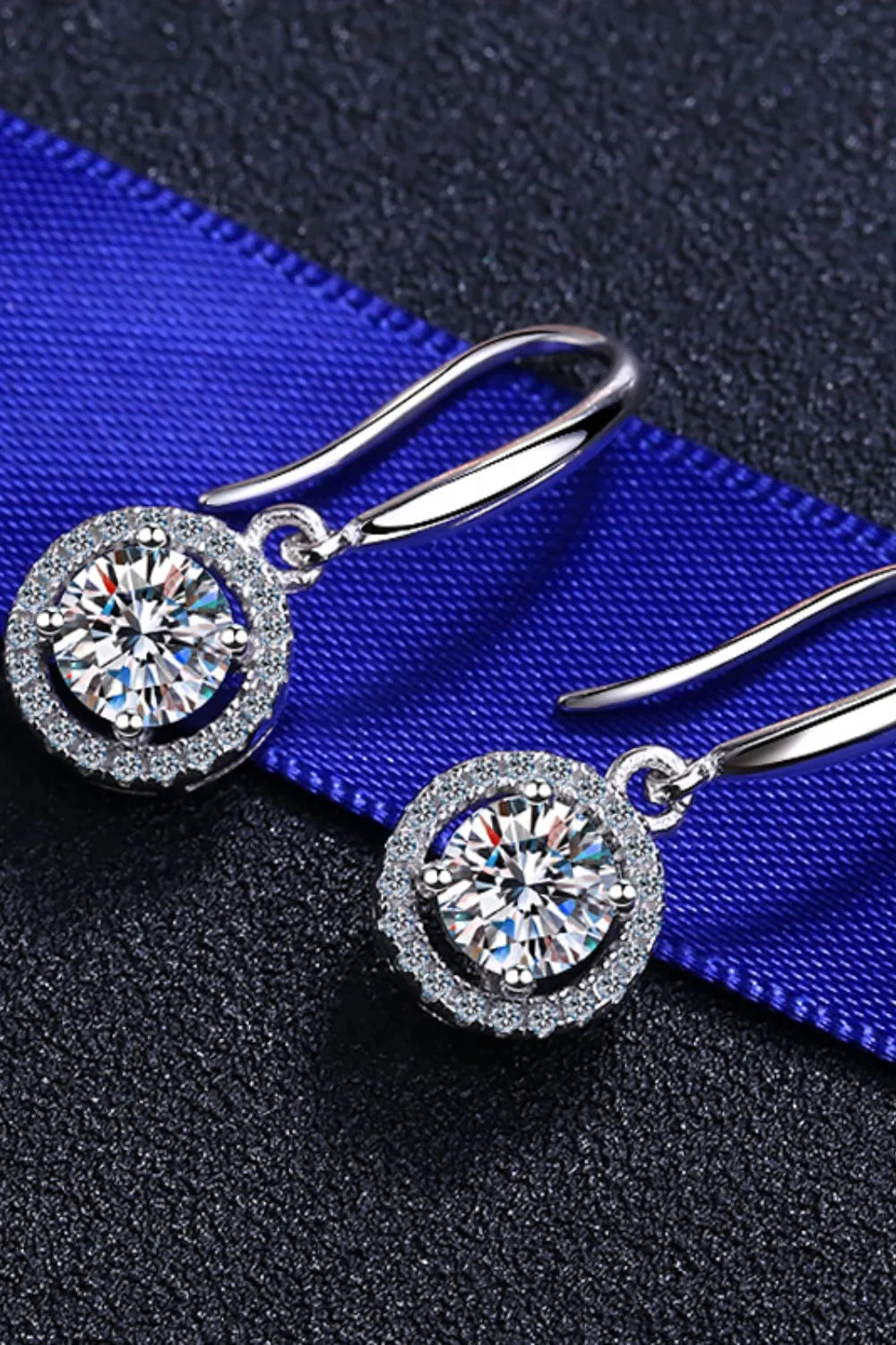 Silver moissanite halo drop earrings with sparkling round-cut center stones.