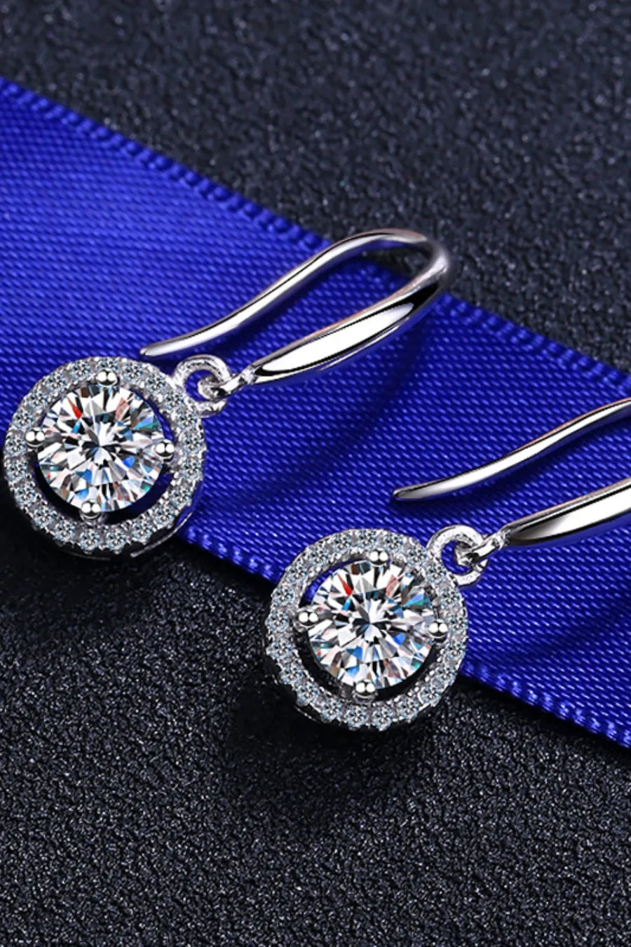 Silver moissanite halo drop earrings with sparkling round-cut center stones.