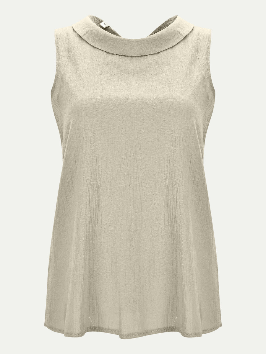 Sleeveless Peter Pan collar blouse in Eggshell with textured fabric.