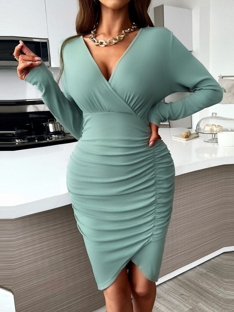 Greyish green ruched surplice bodycon dress with long sleeves and V-neck.