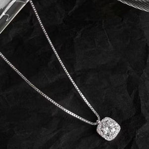 Sterling silver square pendant necklace with dazzling stones on a delicate chain.