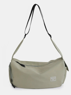 Sage slouchy crescent crossbody bag with adjustable strap and zippered pockets.