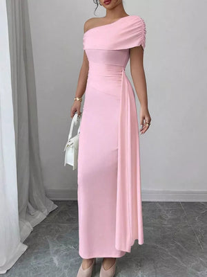Pink asymmetrical ruched maxi dress with one-shoulder neckline and draped detail.