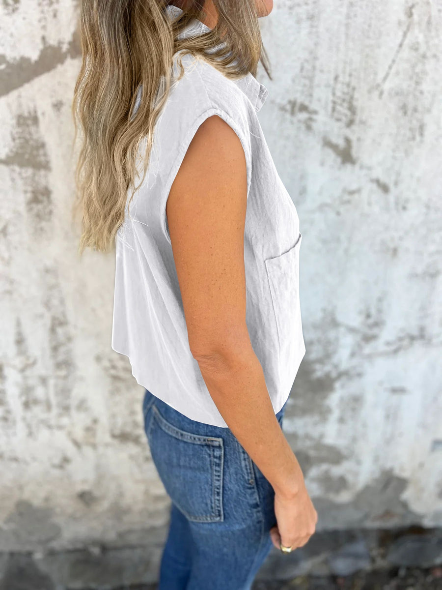 White button-down cap sleeve cropped shirt with a chest pocket.