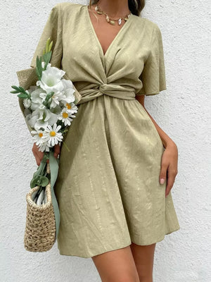 Twist waist mini dress with flutter sleeves and a V-neck in olive green.
