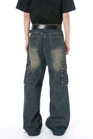 Dark wash distressed wide-leg cargo jeans with zippered pockets.