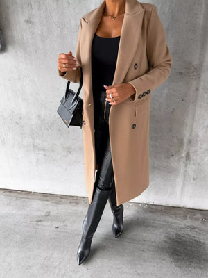 Chic double-breasted longline trench coat in apricot with button details.
