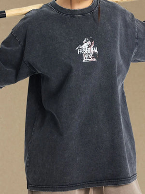 Black vintage wash graphic tee with a distressed neckline and a small front graphic.