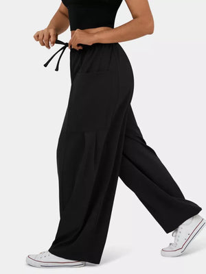 Black maternity pants with adjustable drawstring waist and wide legs.