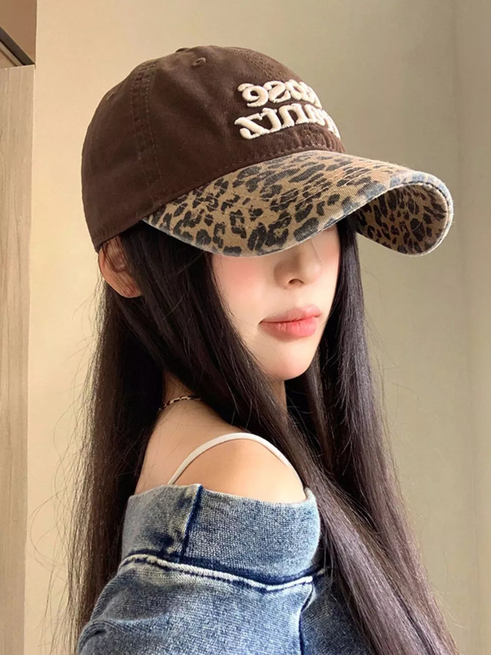 Brown cotton baseball cap with leopard brim and embroidered text
