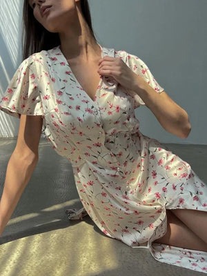 Satin floral print midi dress with V-neck, short flutter sleeves, and button front.