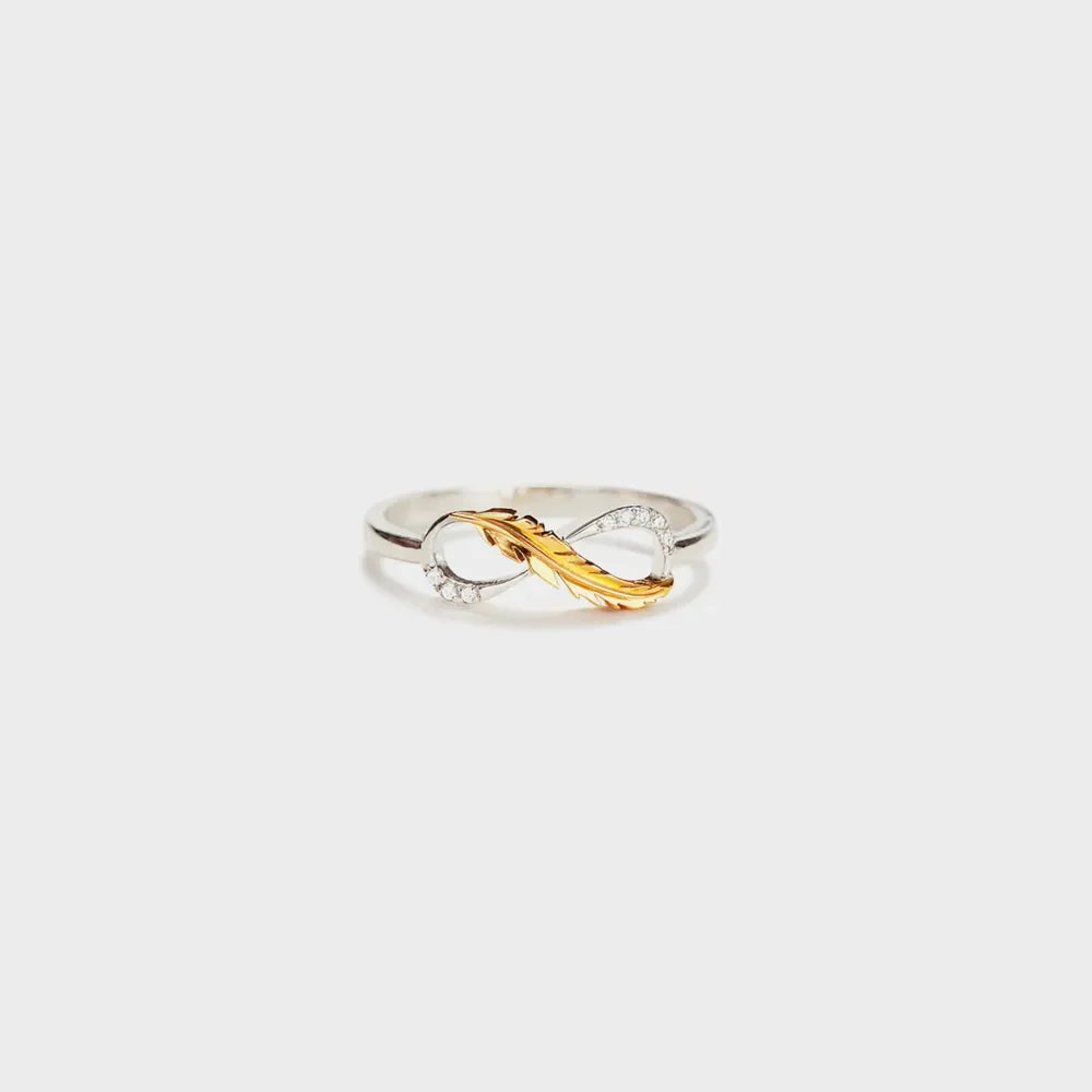 Sterling silver infinity ring with gold feather detail and small diamonds