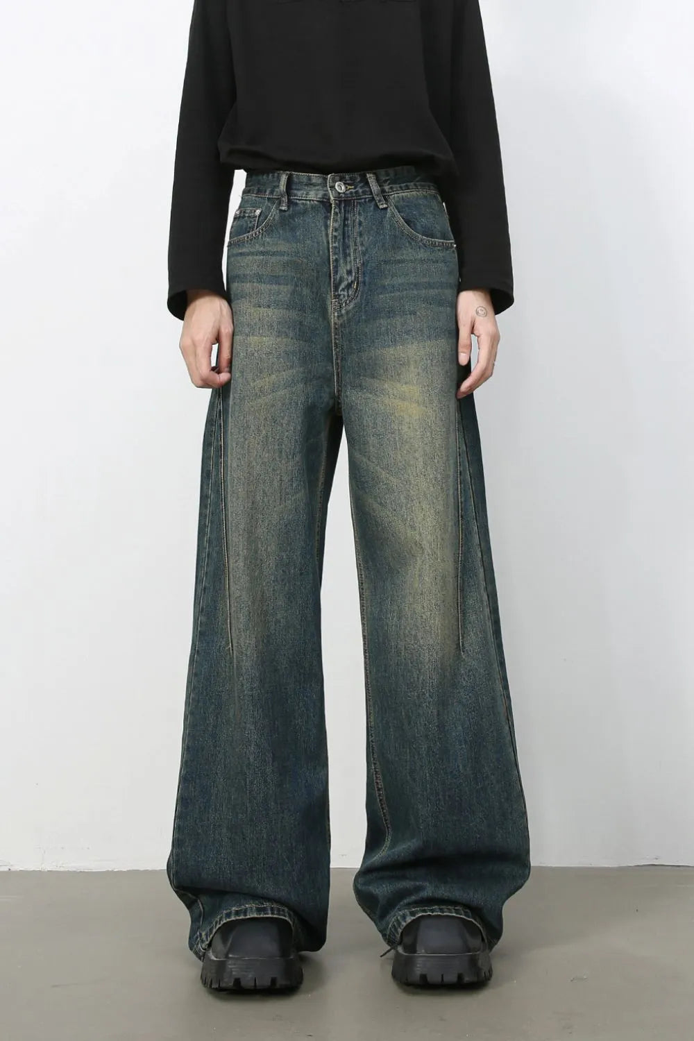 Dark wash wide-leg denim jeans with a faded, distressed look.