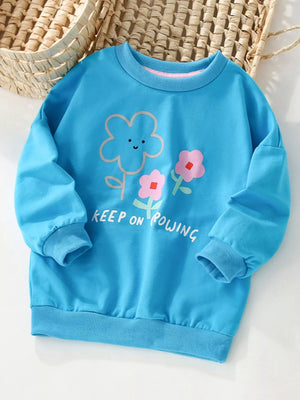 Sky blue cotton sweatshirt with floral print and text graphic.