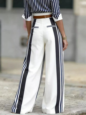 Wide leg pants with black and navy stripes, high waist, and a brown belt.