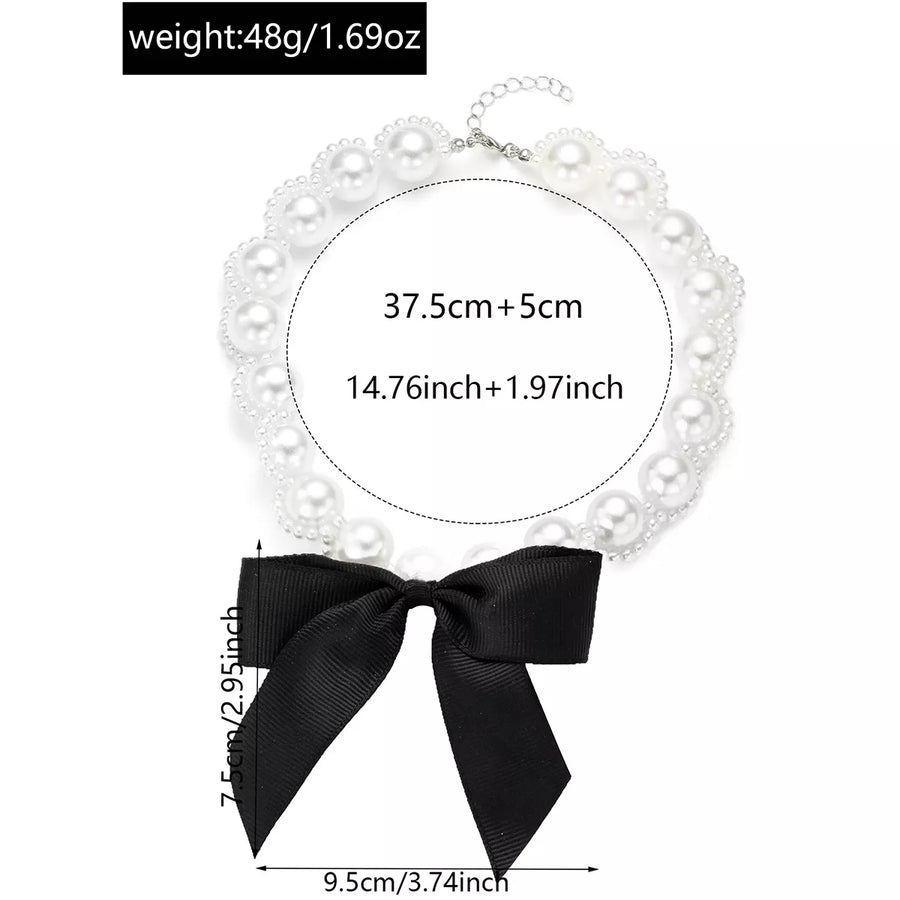 Pearl choker necklace with black bow detail and adjustable chain.