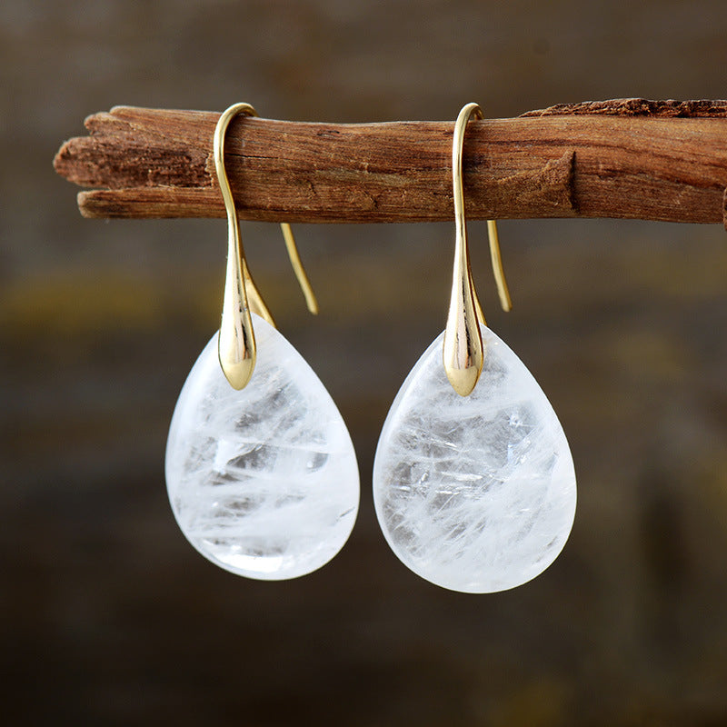 Gemstone teardrop leverback earrings with gold accents in white.