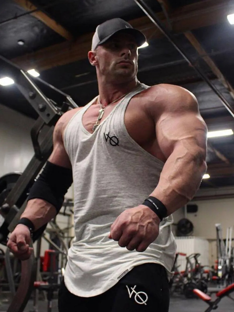 Gray racerback tank top with roundneck and subtle logo detail.