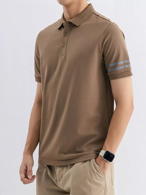 Men's camel cotton polo shirt with grey striped sleeves and a classic collar.