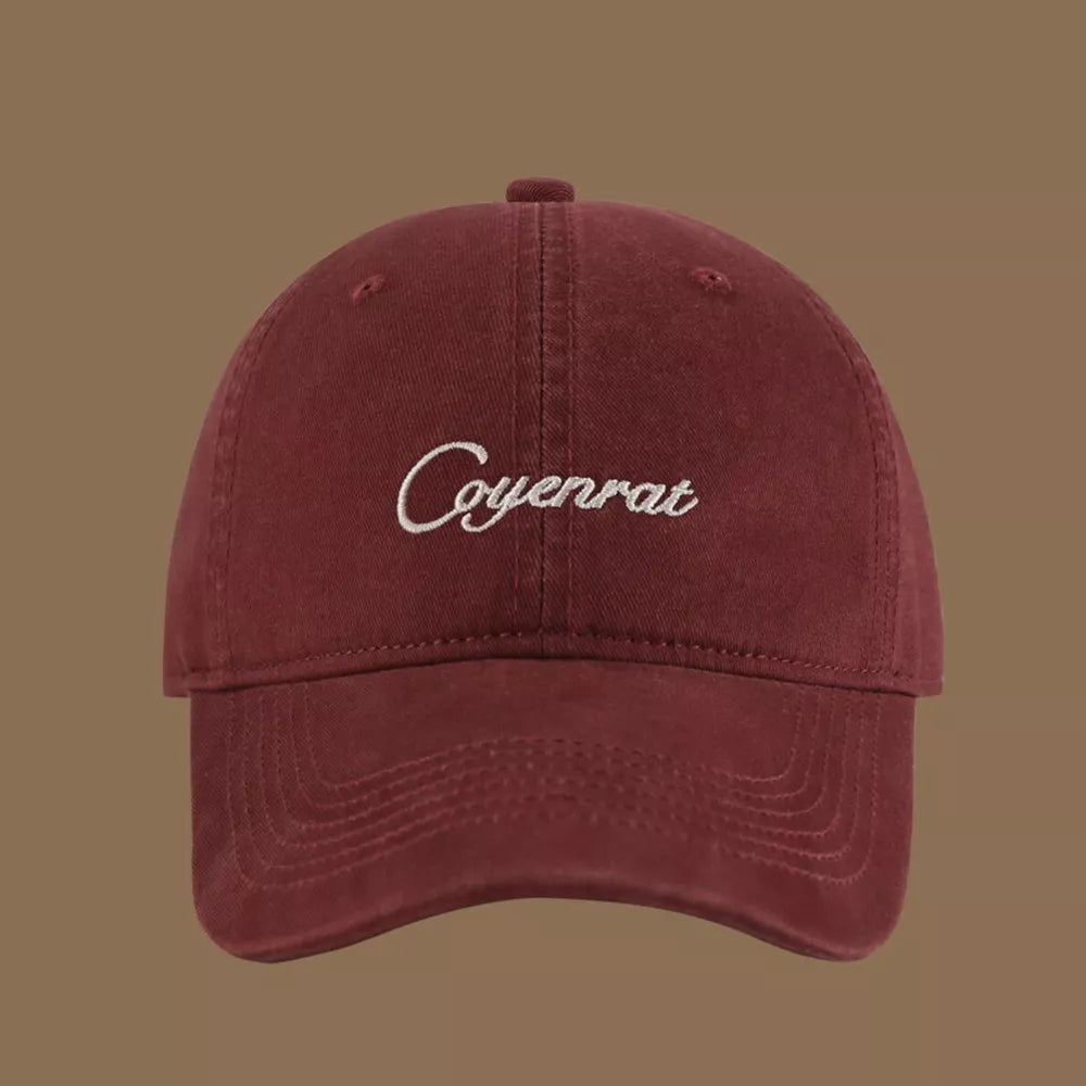 Maroon baseball cap with white embroidered text