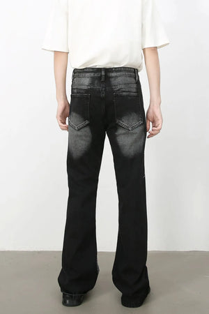 Distressed flare jeans in dark shadow wash denim with a bootcut leg.