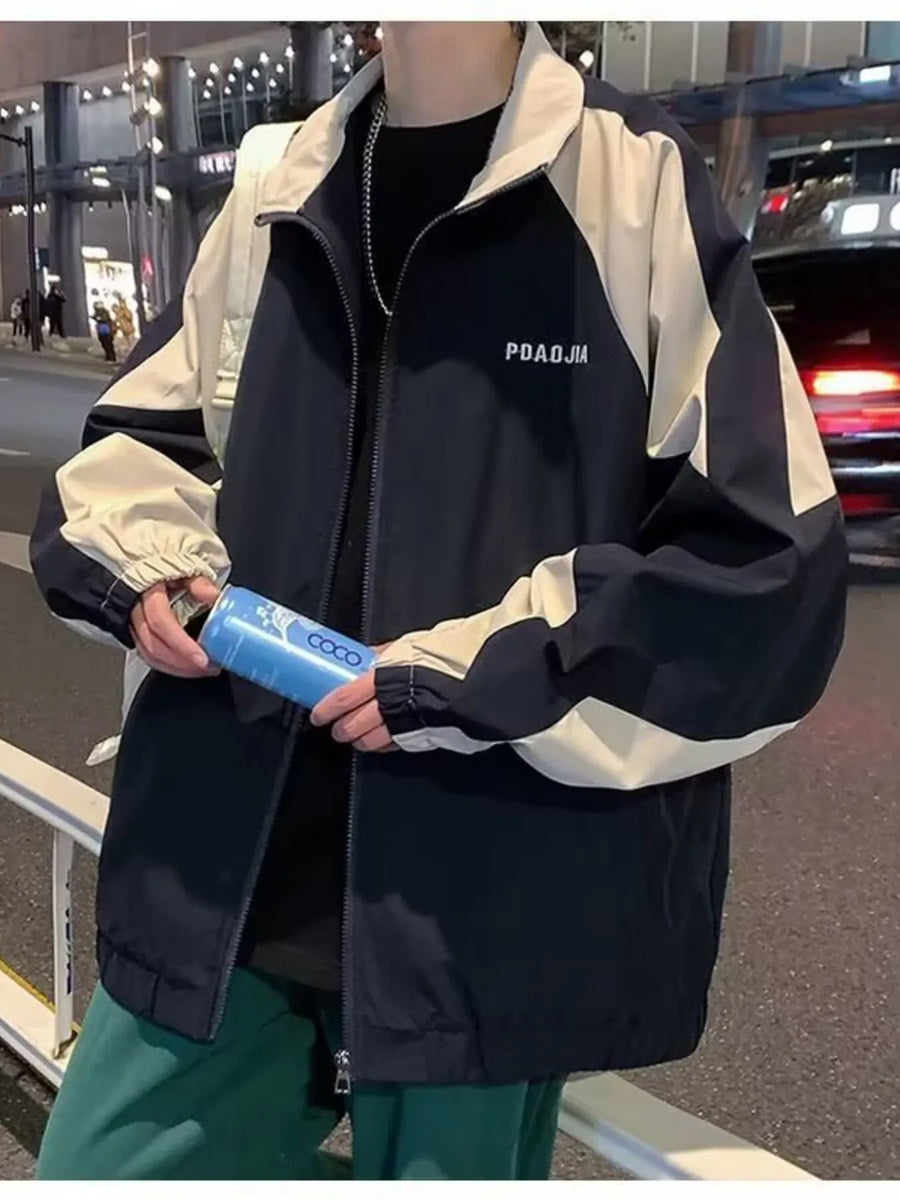 Plus-size two-tone windbreaker jacket in black and beige with a zip front and elastic cuffs.
