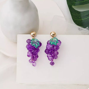 Grape-inspired beaded dangle earrings with purple acrylic beads and green leaf accents.