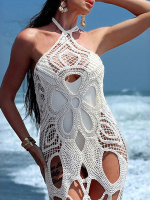 White crochet halter dress with intricate floral pattern and open knit details.