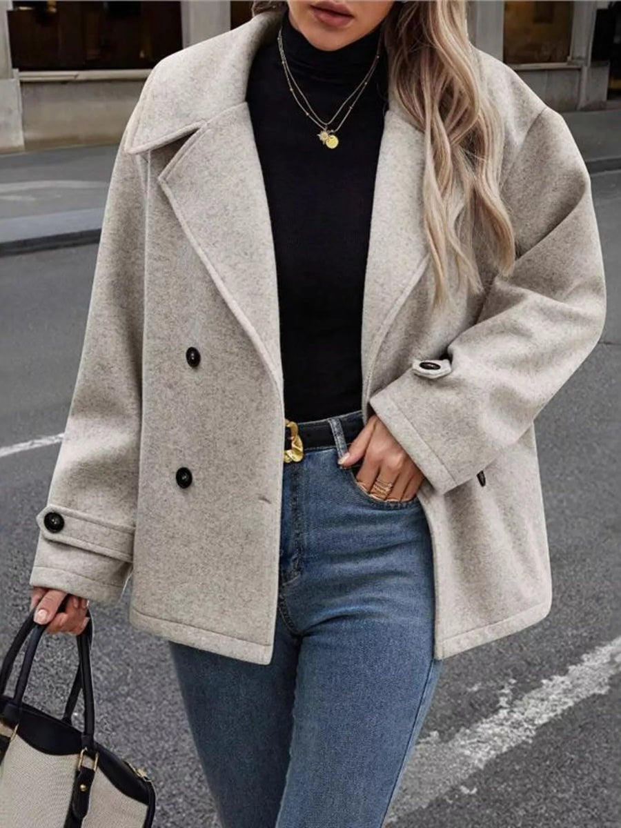 Light gray double-breasted wool blend pea coat with button details and lapel collar.
