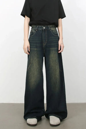 Faded wash palazzo jeans in dark denim with a wide leg and distressed details.