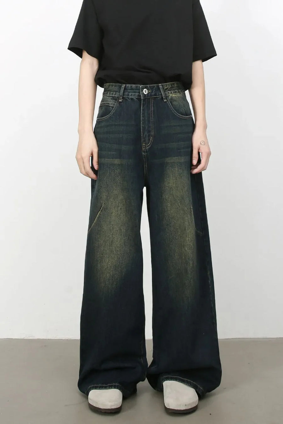 Faded wash palazzo jeans in dark denim with a wide leg and distressed details.