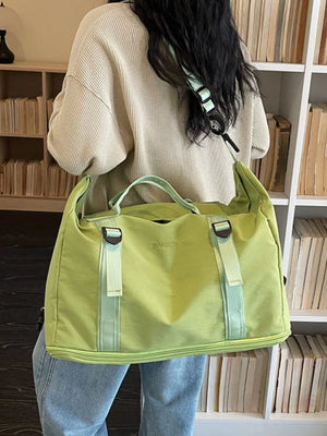 Green nylon travel bag with buckle straps and adjustable shoulder strap.