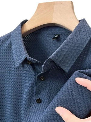 Textured pique polo shirt in Dusty Blue with a refined collar and button placket.