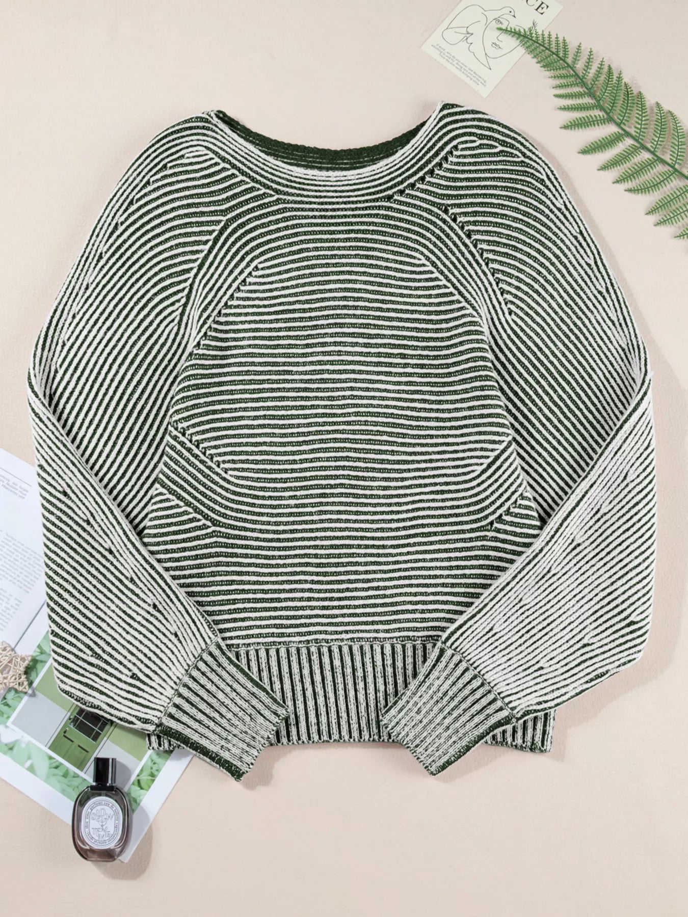 Relaxed ribbed knit sweater with boat neck and stripe pattern in green and white.