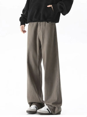 Brown wide-leg comfort fit jeans in cotton blend, styled with a black hoodie.