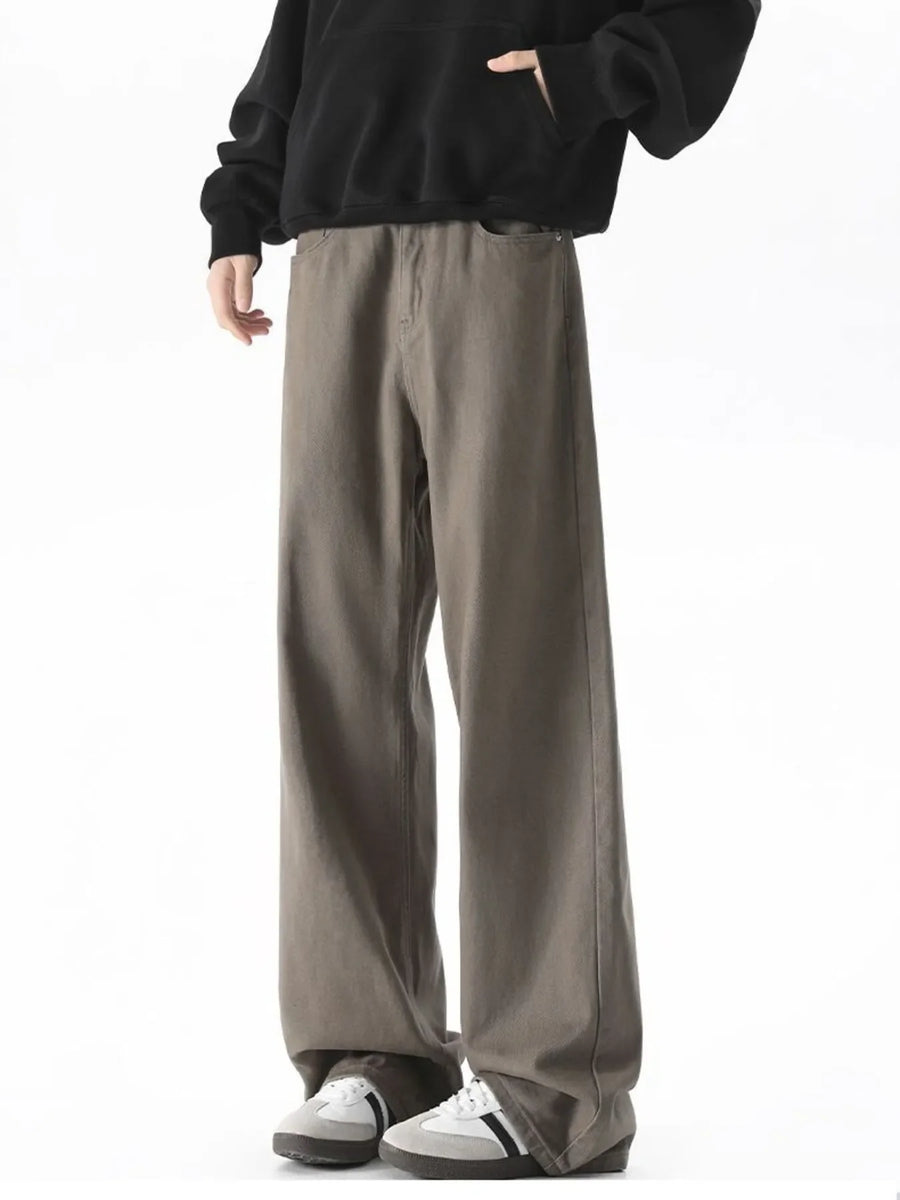 Brown wide-leg comfort fit jeans in cotton blend, styled with a black hoodie.