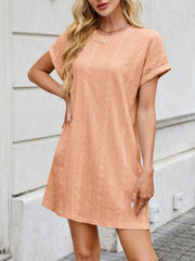 Eyelet mini dress in watermelon pink with diamond pattern, crew neck, short sleeves, and A-line cut.