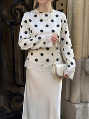 black blouse featuring lace detail and polka dot