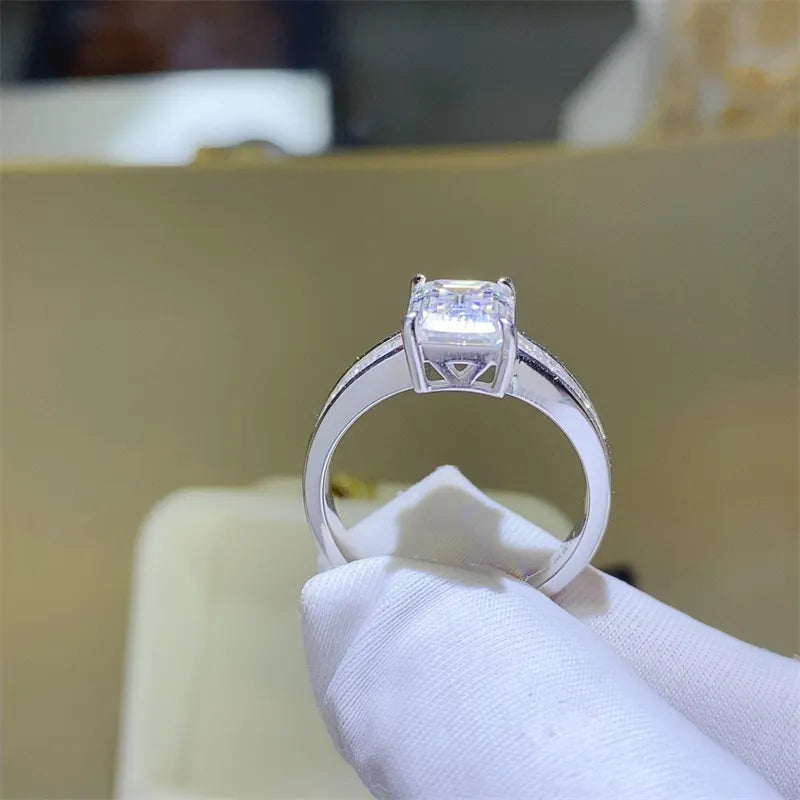 Emerald cut moissanite ring in silver with baguette accents