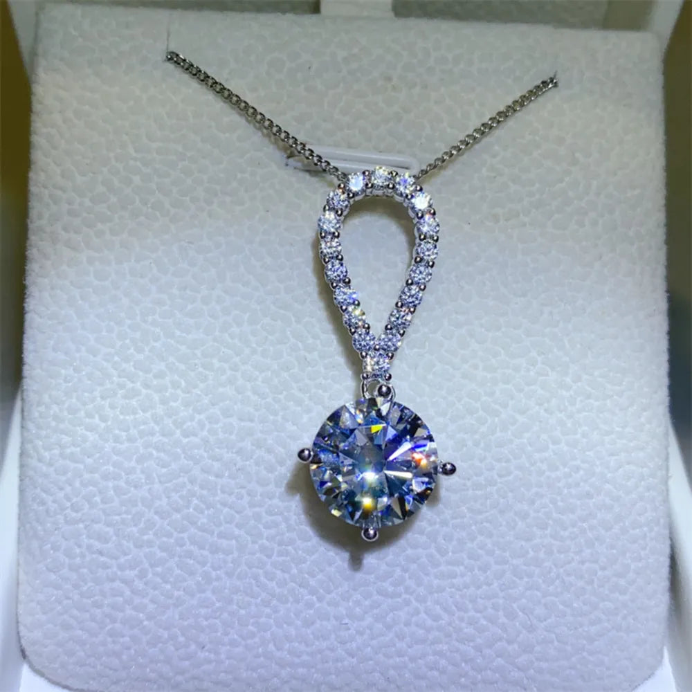 Silver pavé halo solitaire pendant necklace with a large round-cut diamond.