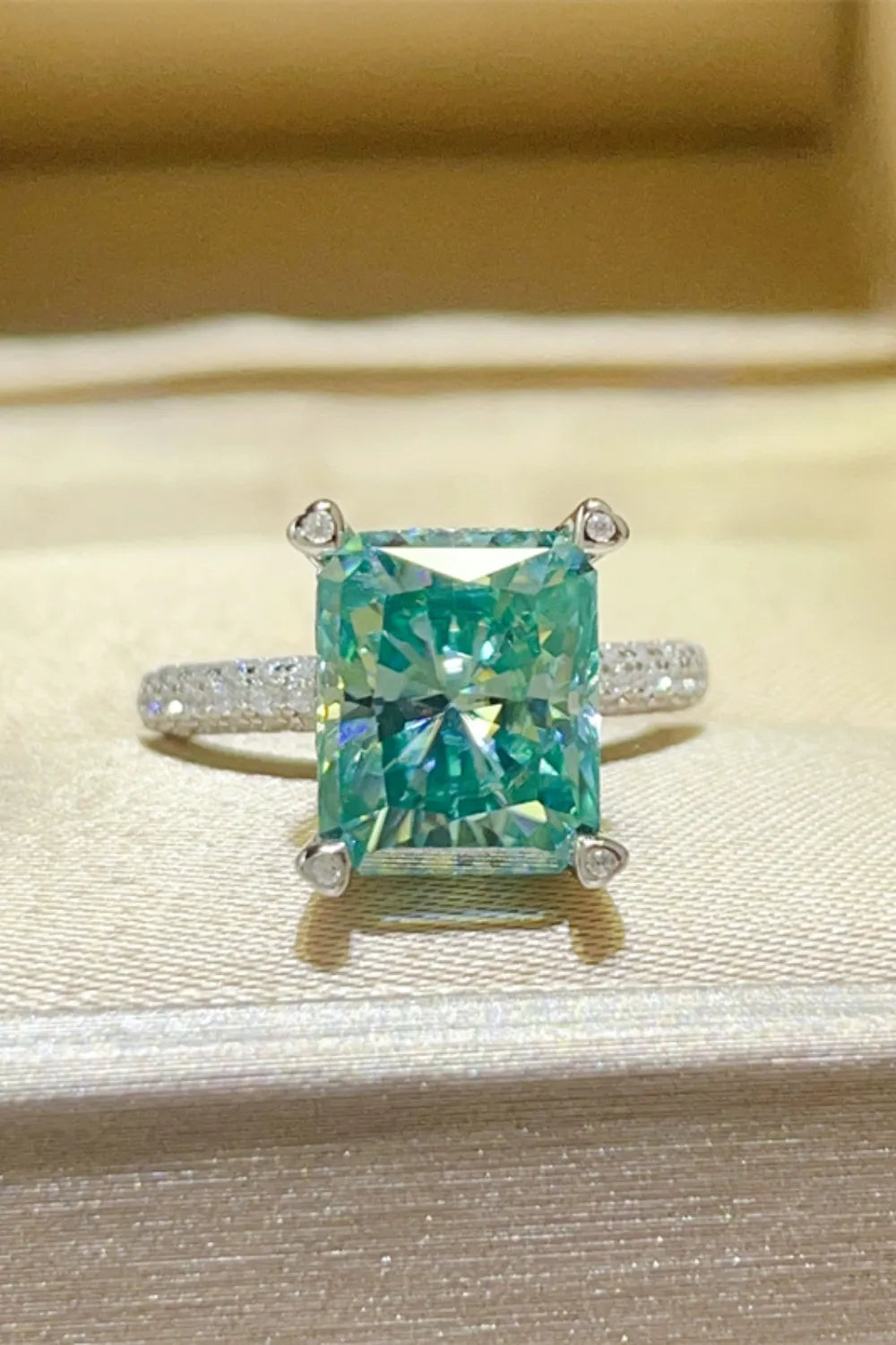 Radiant emerald cut teal pave ring with diamond accents